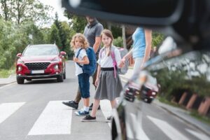 group of young children walking on a pedestrian lane