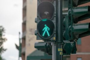 Close-up of a green pedestrian traffic light signal, indicating it's safe to walk.