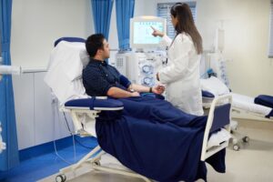 Doctor explains medical results to a patient during an exam after a car accident, ensuring no hidden injuries.