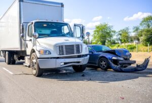 semi-truck accident with a car on the road.