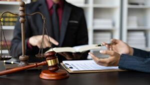 Businessman and lawyer engaged in discussion with a legal advisor in a law office, representing legal and justice consulting services.